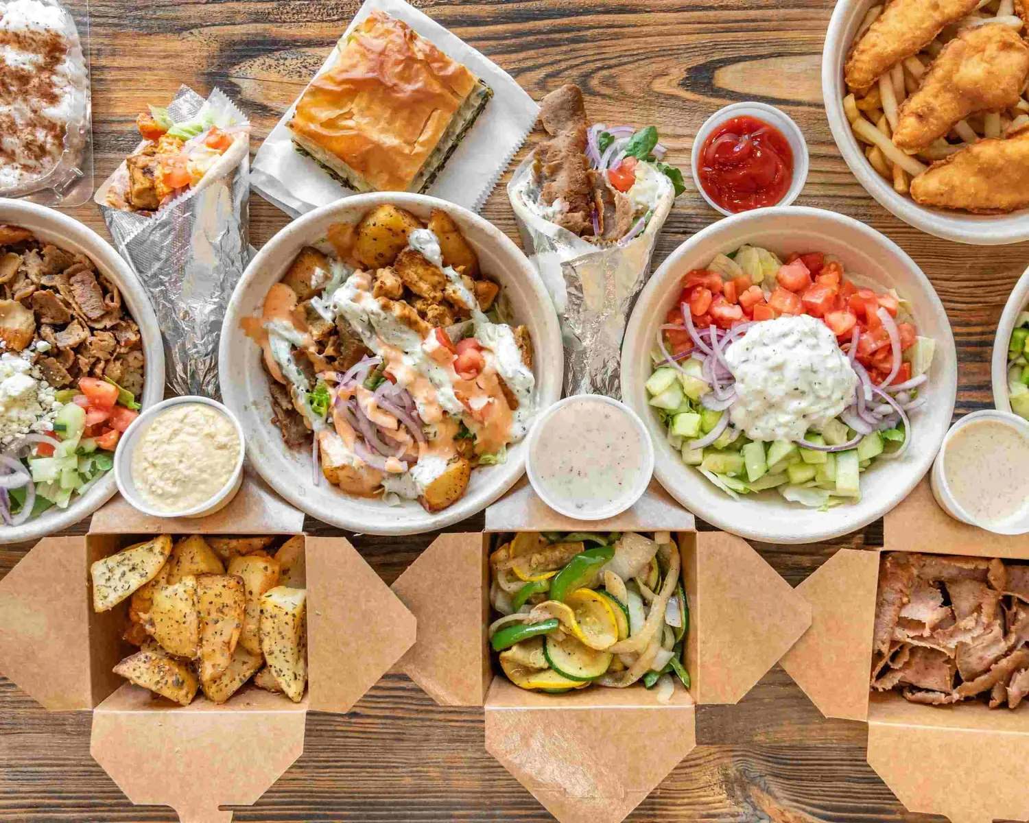 Pita Grill House dishes — gyros, build-your-own bowls, Greek salad, fries, and dips